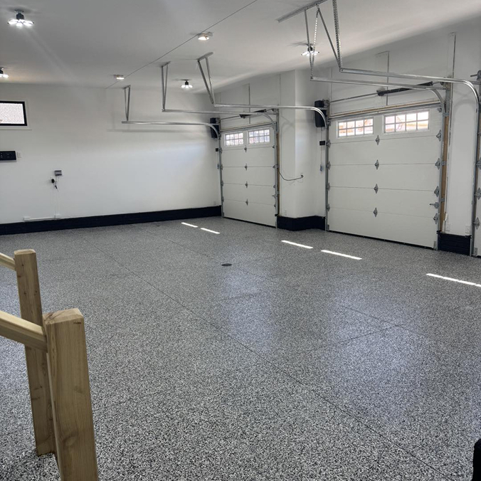 Residential garage floor with gray and black paint coating.
